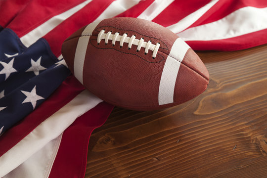 Football With American Flag On Dark Pine Wood Background