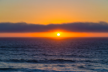 Cloudy sunset over ocean near Cascais, Portugal