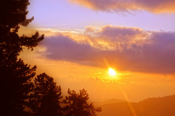 Sunset at mountain behind the clouds at lake Neelam