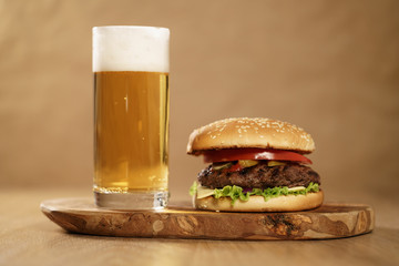 homemade hamburger with beer on background