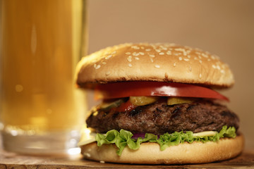 homemade hamburger with beer on background