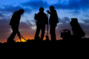 Construction Workers with Truck at Sunset Silhouette