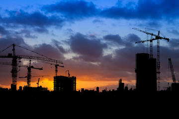 Building Site Silhouette with Cranes at Sunset