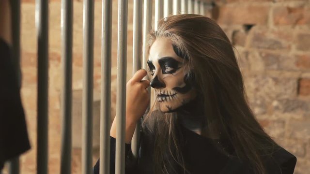 Sexy devilish female vampire flirting with other vampires near lattice