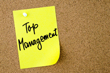 Top Management text written on yellow paper note