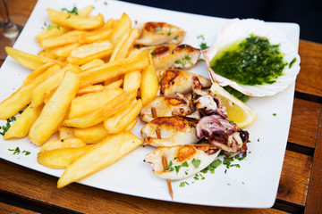 Fried calamari served with fries at a restaurant