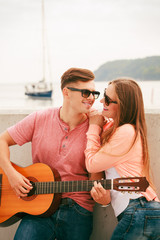 Happy couple with guitar outdoor