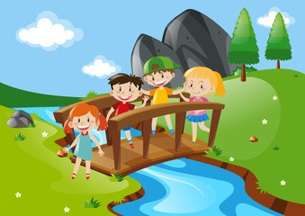 Four kids crossing bridge