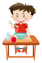 Boy eating from bowl on the table