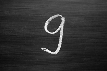 number nine enumeration written with a chalk on the blackboard