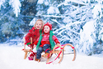 Fototapeta na wymiar Kids having fun on a sleigh ride in winter