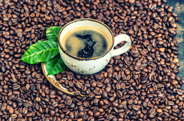 Black coffee drink green leaves coffee beans background vintage