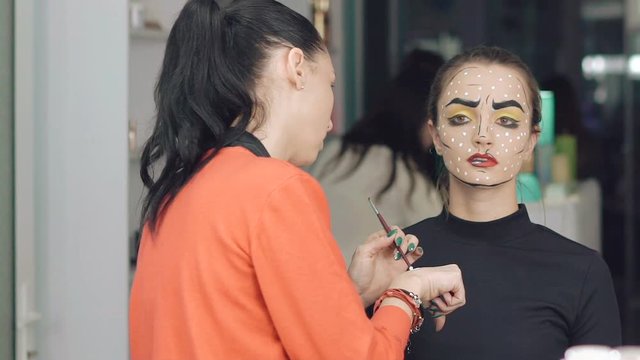 Make up artist make the girl halloween makeup in studio
