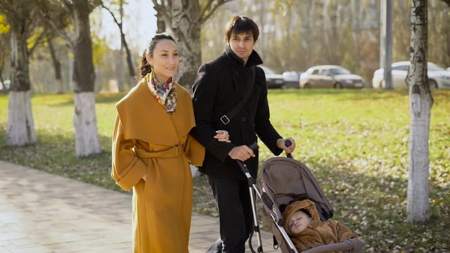 Young girl and a man walks along the avenue of the city