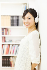 attractive asian woman listening music