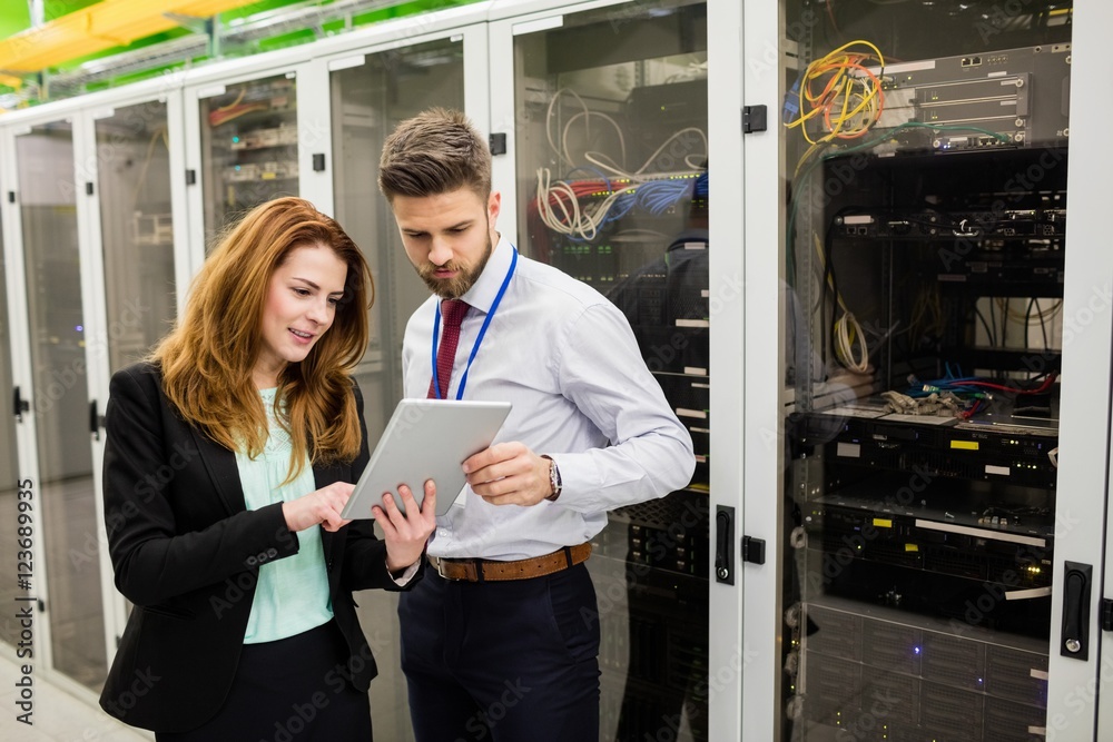 Aufkleber Technicians using digital tablet while analyzing server