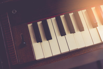 Closeup of antique piano keys and wood grain with sepia tone