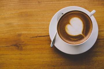 Coffee cup top view on wooden table background