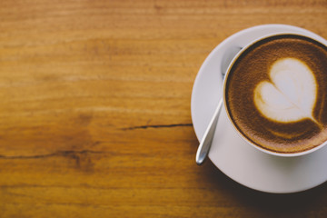 Coffee cup top view on wooden table background