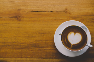 Coffee cup top view on wooden table background