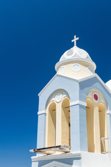 A fragment of a white church with a cross