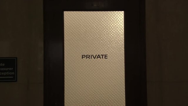 Door read Private inside government building with camera zoom in.