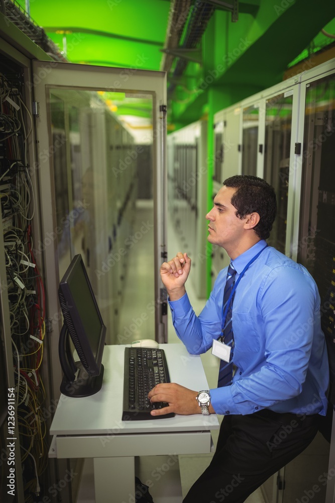 Aufkleber Technician working on personal computer while analyzing server