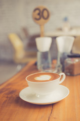 A cup of coffee latte made with vintage filter.