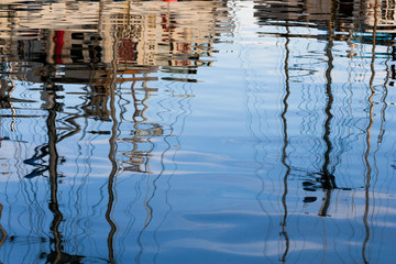 Abstract reflections of fishing boats in the water
