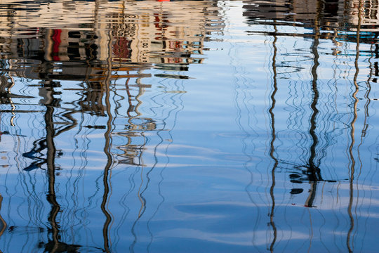 Abstract reflections of fishing boats in the water
