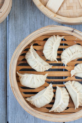 Fototapeta na wymiar Eight Chinese dumplings in a steamer basket, eight is a lucky number in Chinese culture, traditional dish for Lunar New Year 
