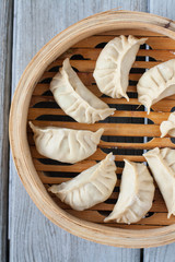 Fototapeta na wymiar Eight Chinese dumplings in a steamer basket, eight is a lucky number in Chinese culture, traditional dish for Lunar New Year 