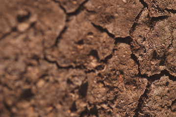 Crack soil on dry season, Global warming effect. Closeup macro artistic blurred background