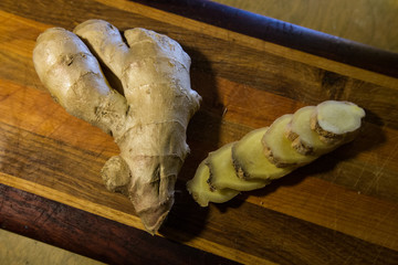 Healthy ginger root sliced on wooden cutting board