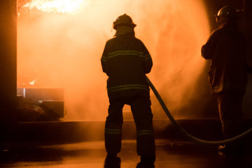 Firefighter attacking a burning structure