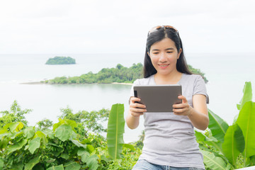 Fototapeta premium asian woman selfie with seascape against blue sky
