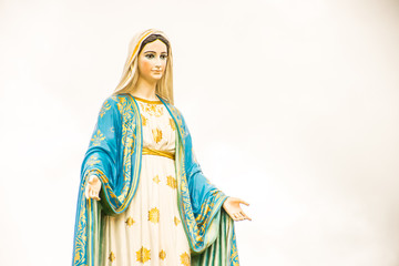 Statues of Holy Women on cloudy sky background