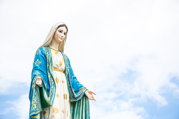 Statues of Holy Women on cloudy sky background