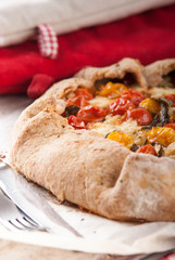 delicuious pie with cherry tomatoes, feta cheese herbs