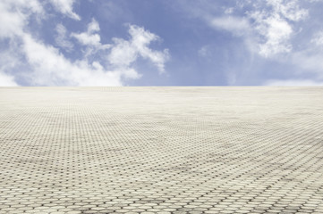 Fototapeta na wymiar patterned paving tiles with blue sky background