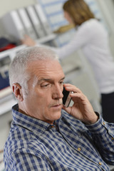 Senior office worker on the phone