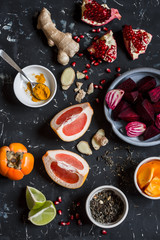 Ingredients for cooking beet and ginger detox elixir. On a dark background, top view