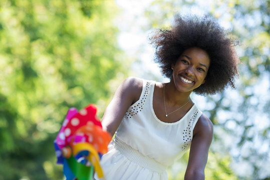 Pretty Young African American Woman Riding A Bike In Forest