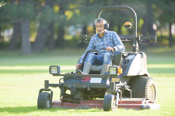 worker mowing the park