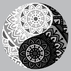 Drawing of a black and white mandala (round ethnic ornament) in shape of symbol yin yang