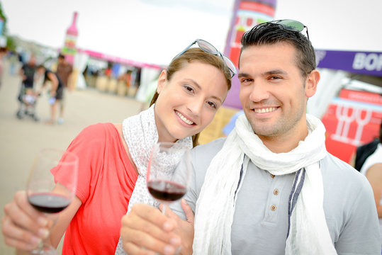 Couple with glasses at a wine fair