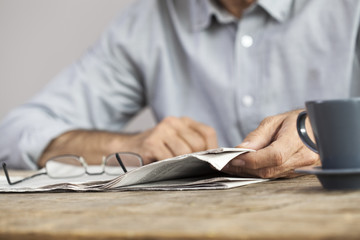 Man newspaper reading on table