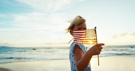Cute young girl with American Flag on beach at sunset - Powered by Adobe