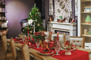 Served table in empty room decorated for Christmas. Thanksgiving table, decorated with fresh pine and candles.