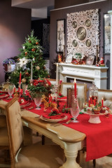Served table in empty room decorated for Christmas. Thanksgiving table, decorated with fresh pine and candles.